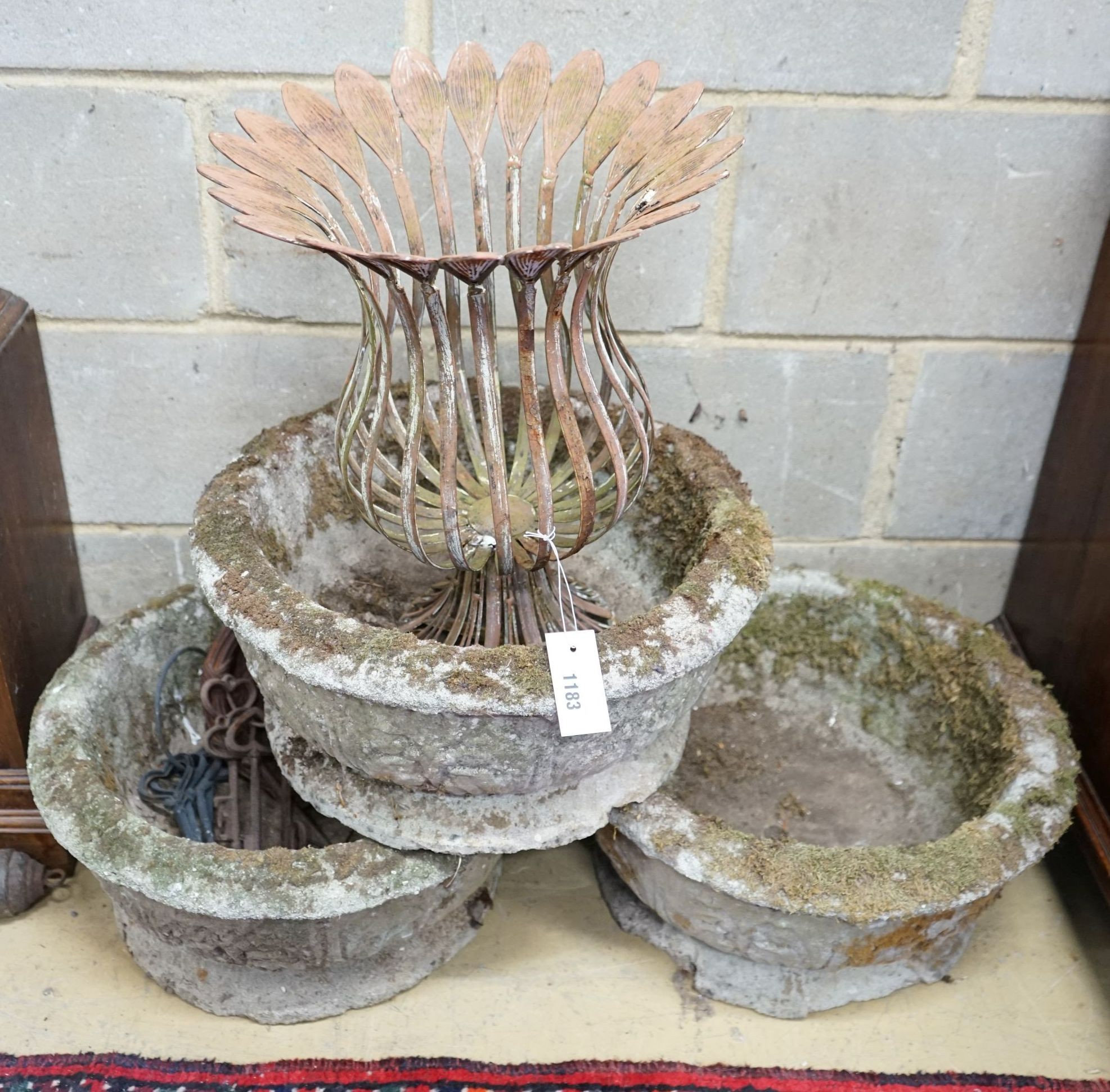 A set of three circular reconstituted stone garden planters, diameter 46cm, together with a metal planter and sundry garden ornaments